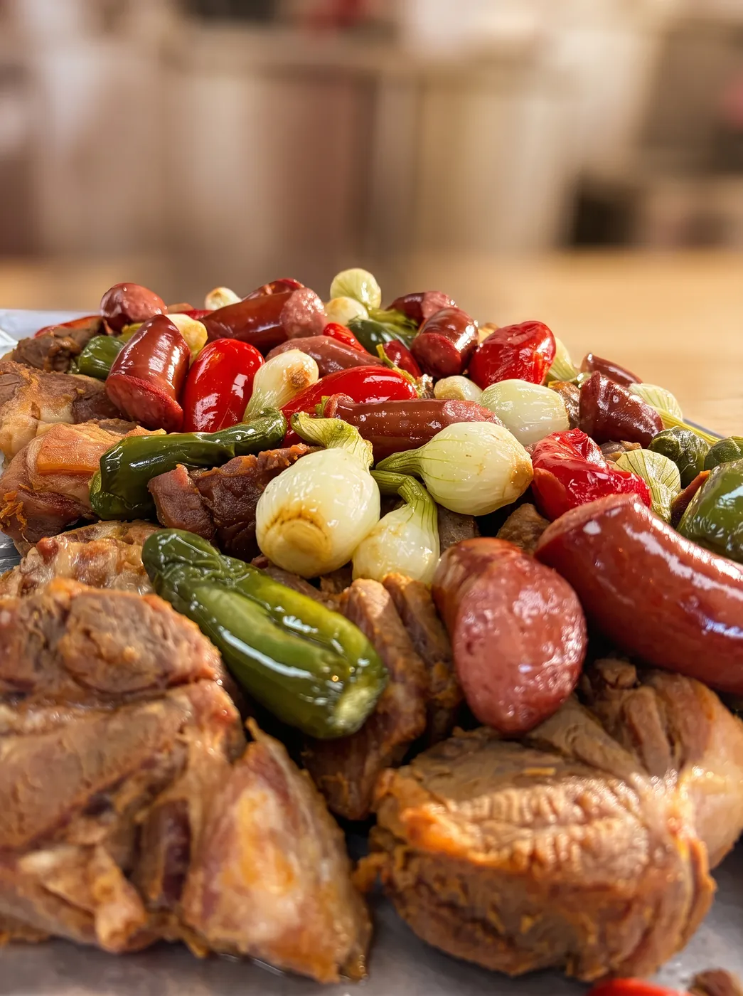 Close-up of slow-cooked pork with grilled jalapeños, spring onions and sausage